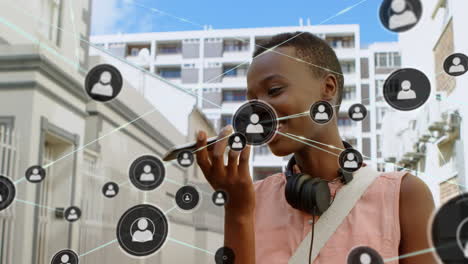 animation of network of profiles over african american woman talking on smartphone on the street