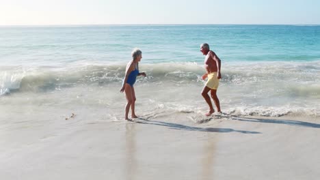 Old-retired-couple-playing-in-the-sea