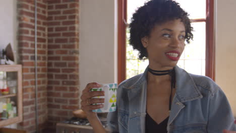 Three-adult-girlfriends-talking-in-kitchen,-panning-shot,-shot-on-R3D