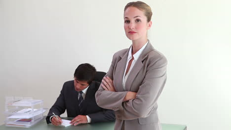 A blonde woman standing in an office