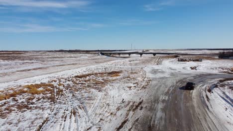 Drone-Following-Vehicle-Going-up-to-Reveal-Bridge