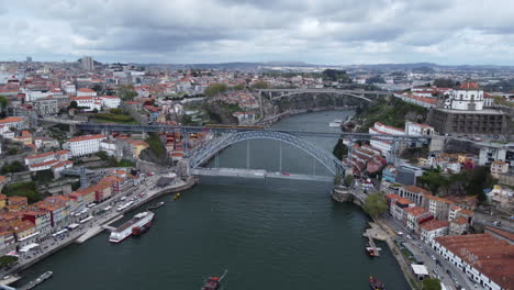 Aerial-View-Of-Dom-Luis-I-Bridge-Between-The-City-of-Porto-And-Vila-Nova-de-Gaia-Over-Douro-River-In-Portugal