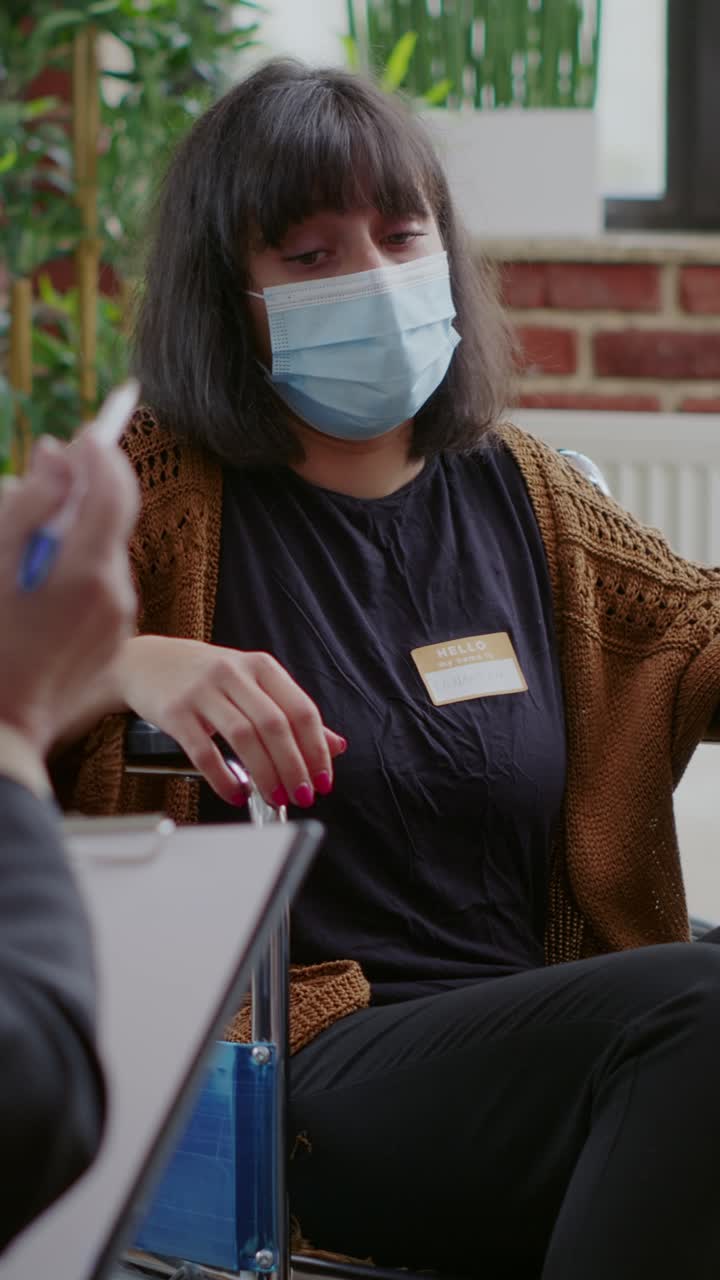 Woman in Wheelchair Wearing Mask at Therapy Session