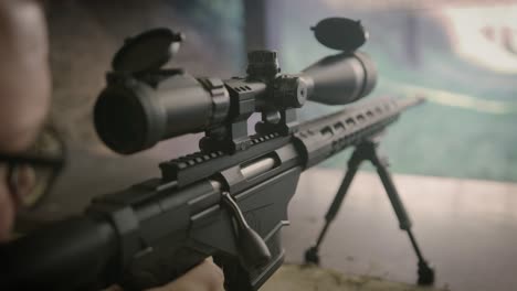 shooter firing sniper rifle on shooting range, close up on weapon