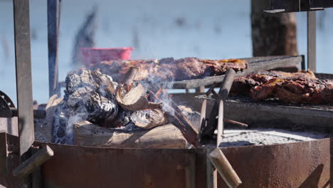 close up of traditional argentine asado meat grilling over wood fire