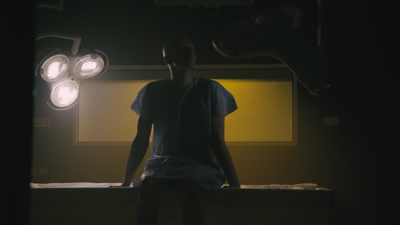 A bald man wakes up in the empty operation room