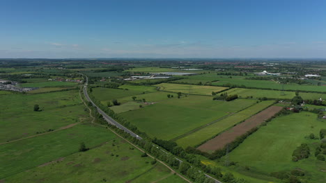 High-aerial-pan-of-the-Beverley-bypass-and-green-fields-on-a-summers-day