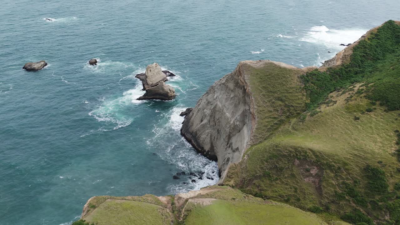 Spectacular coastal cliffs with ocean waves crashing in Chonchi, Chiloe Island, Chile.
