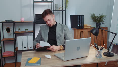 stressed business man worried about financial paperwork problem money debt budget loss at office