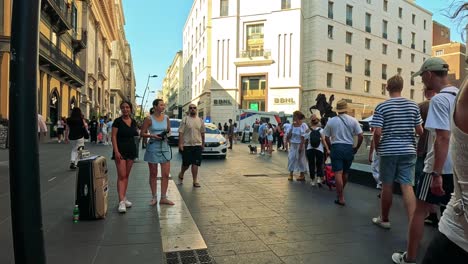 tourists and locals navigate a bustling street