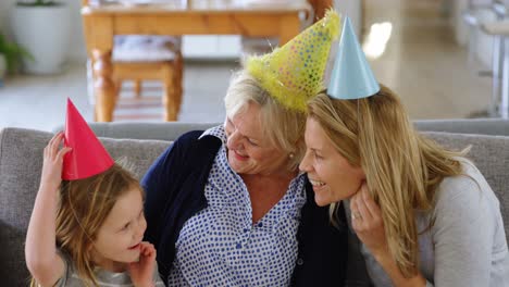 Multi-generation-family-celebrating-birthday-on-sofa-4k