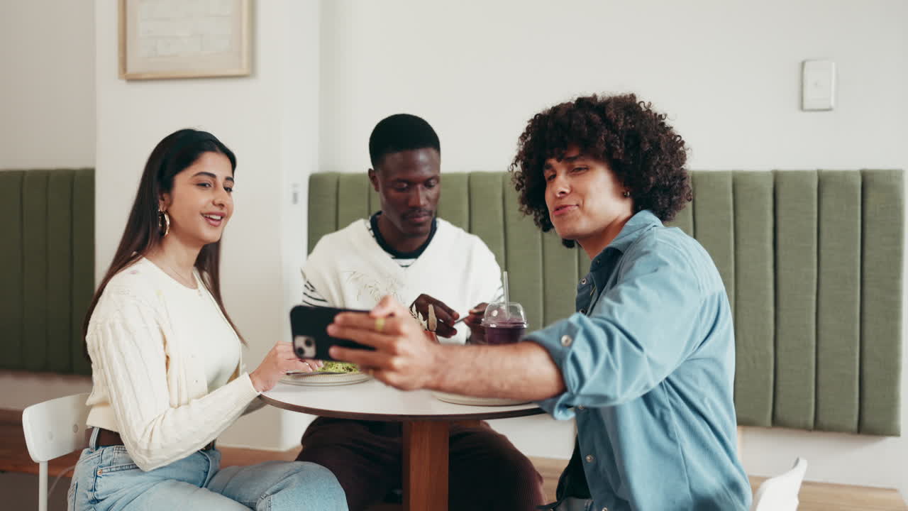 Friends enjoying a meal and taking a selfie