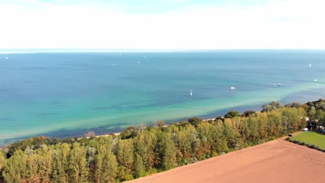 aerial: german north coast in heiligendamm, among trees, fields and the sea