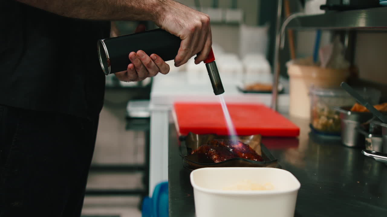 Chef flambeing a dish in a professional kitchen