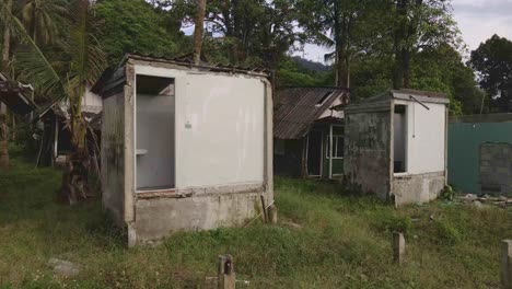 right moving trucking shot of a derelict beach bungalow tourist resort in thailand due to the effect of covid on global travel and tourism