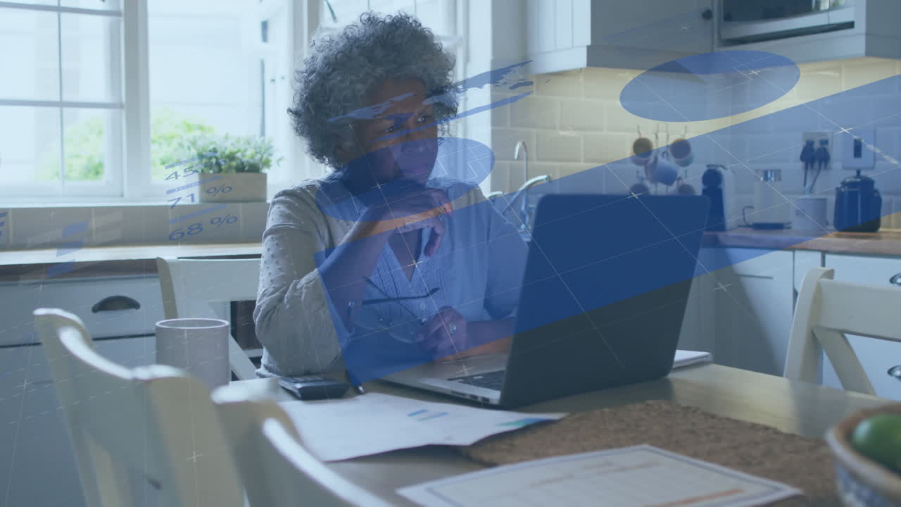 Animation of financial data processing over senior african american woman using laptop