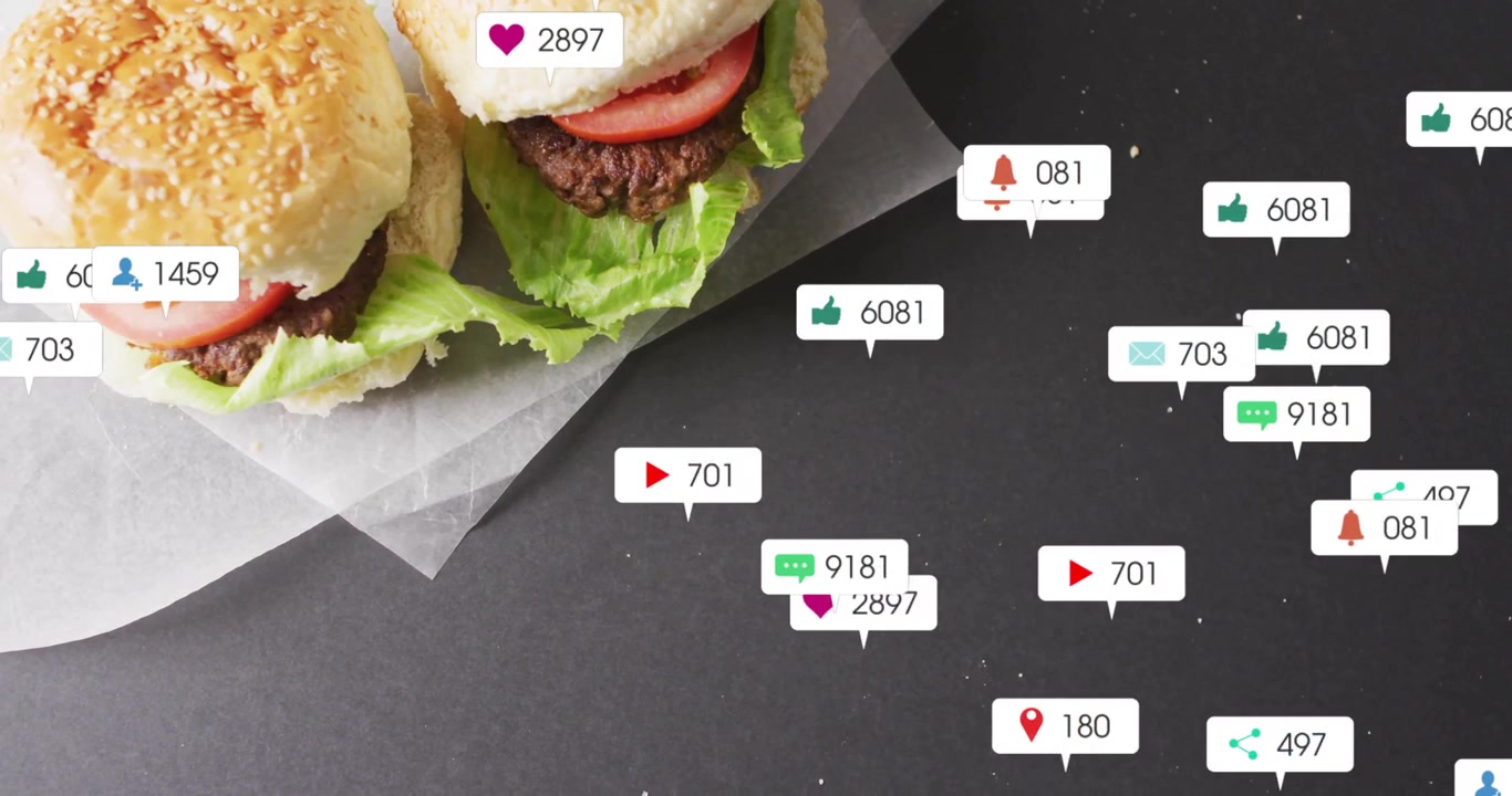 Two sesame burger sliders resting on parchment with social media icons floating as flat design