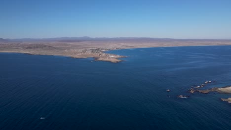 Aerial-tilt-over-view-of-Bahia-Asuncion-coast-on-a-day-with-strong-wind-and-current