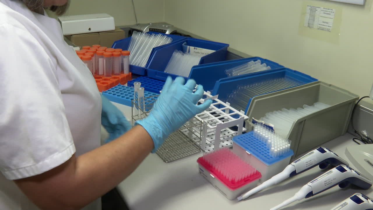 Lab Technician Working with Test Tubes and Equipment
