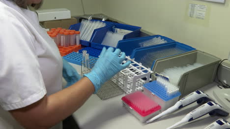 lab technician working with test tubes and equipment