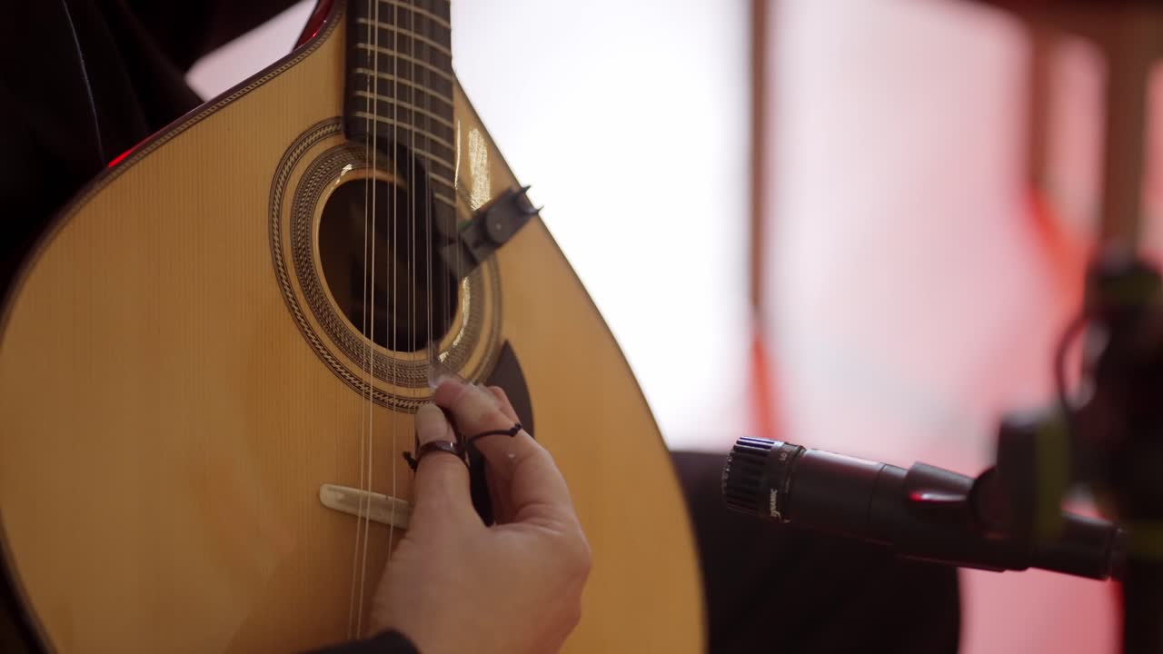 Close up of musician playing Portuguese guitar during live performance