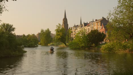 Beautiful-cinematic-view-of-Pond-Ixelles-in-Brussels,-Belgium-during-sunset