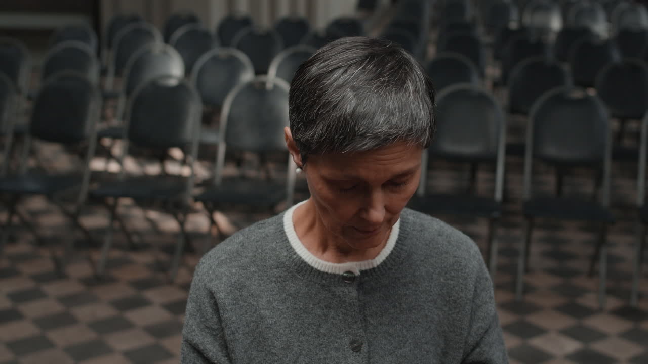 Woman in gray sweater in a church