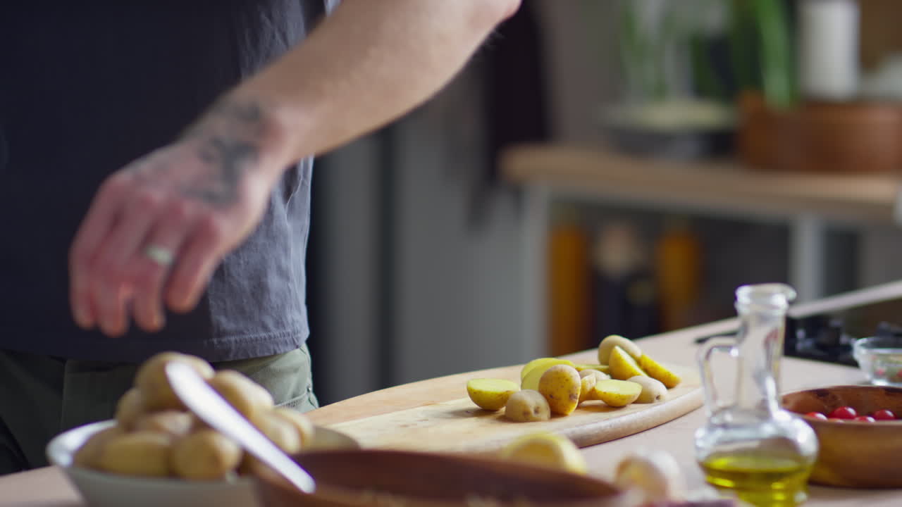 Man Cutting Potatoes before Cooking