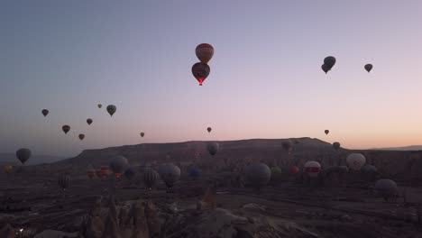 colourful hot air balloons fly over goreme town in cappadocia, turkey