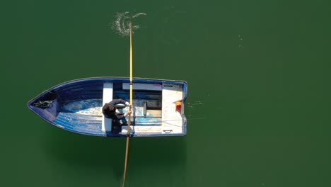 woman on the boat catches a fish on spinning in norway.