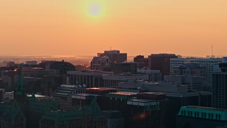 sunrise over the ottawa city skyline on a warm foggy morning