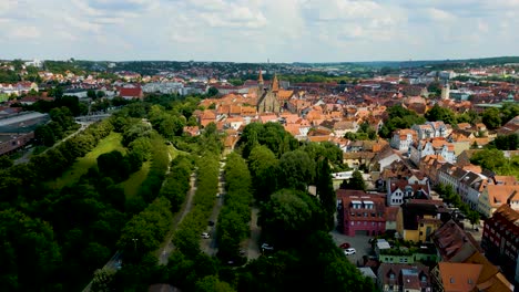 4k aerial drone video of the st. johannis kirche church in downtown ansbach, germany
