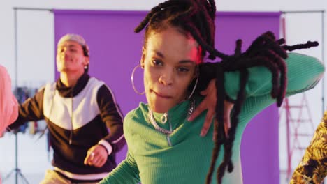 portrait of happy diverse male and female dancers dancing in dance studio, slow motion