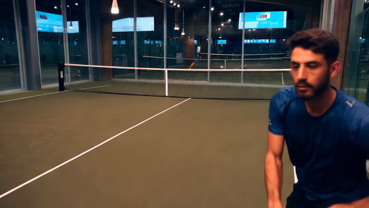 Man playing padel tennis indoor