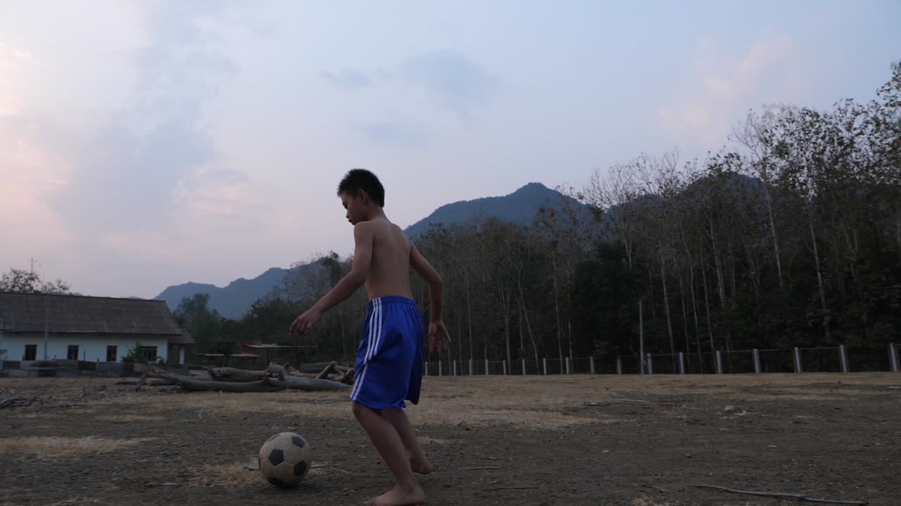 Boy Playing Soccer Outdoors