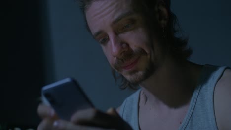 man looking at smartphone at night