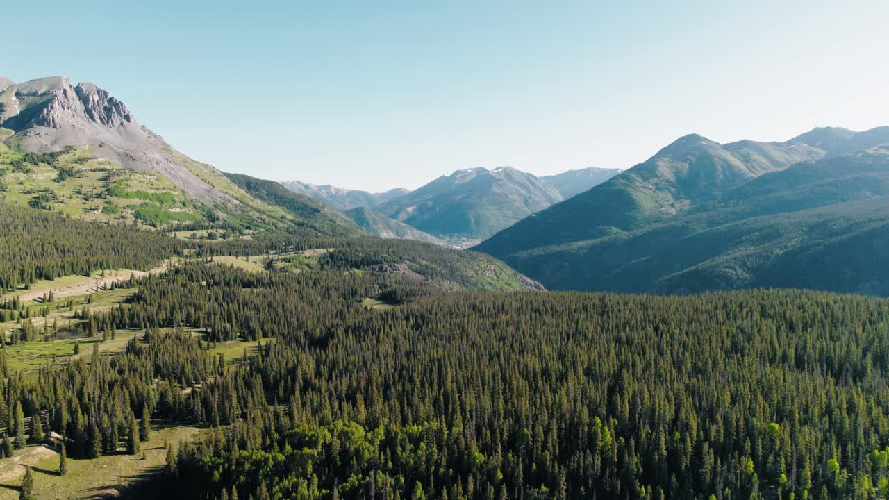 Aerial push in shot of the nature surrounding the San Juan mountain range.