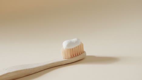 close up of toothbrush with toothpaste on white background