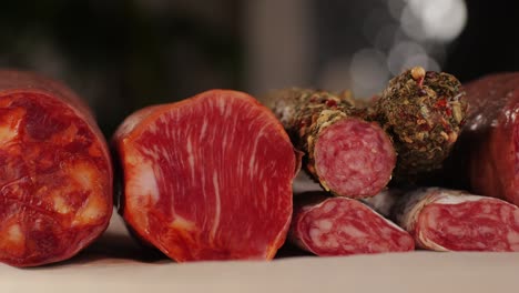 mix of spanish pork sausages, cutting board of appetizing catalonian snack - fuet, jamon, chorizo, olives, supermarket tapas food in spain, traditional cuisine.