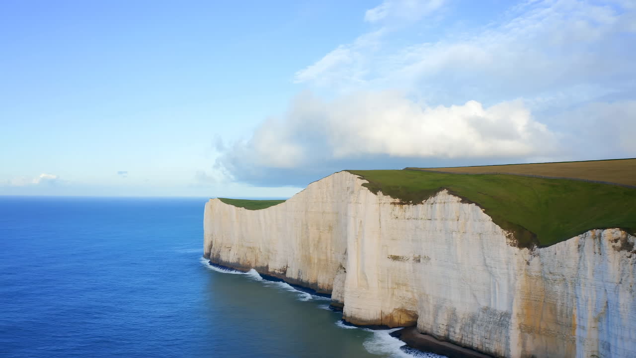 Aerial Chalk Cliffs Coastline Blue Sea, Dramatic White Cliffs Rising From Calm Ocean With Windswept Green