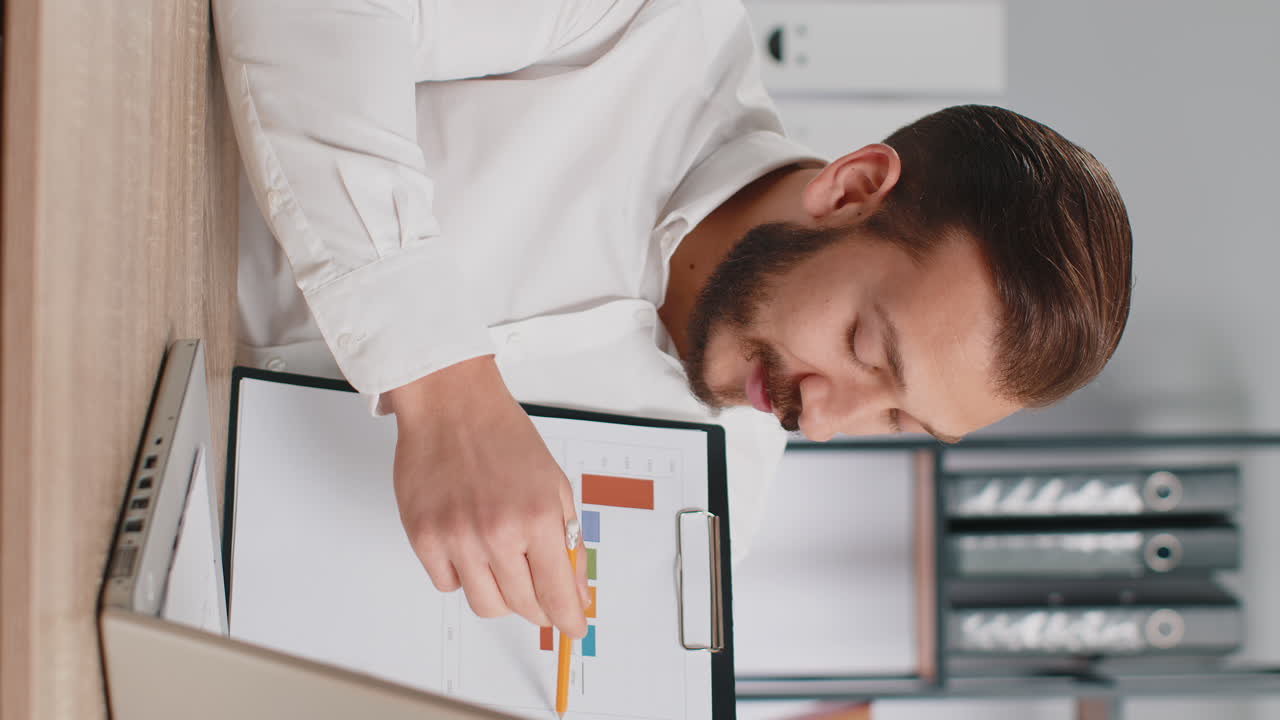 Business man making online presentation video call demonstrates graphic analytics looking at camera