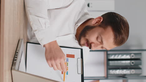business man making online presentation video call demonstrates graphic analytics looking at camera