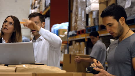 coworkers having discussion on laptop