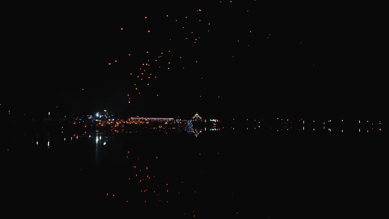 Sky Lanterns over a City at Night