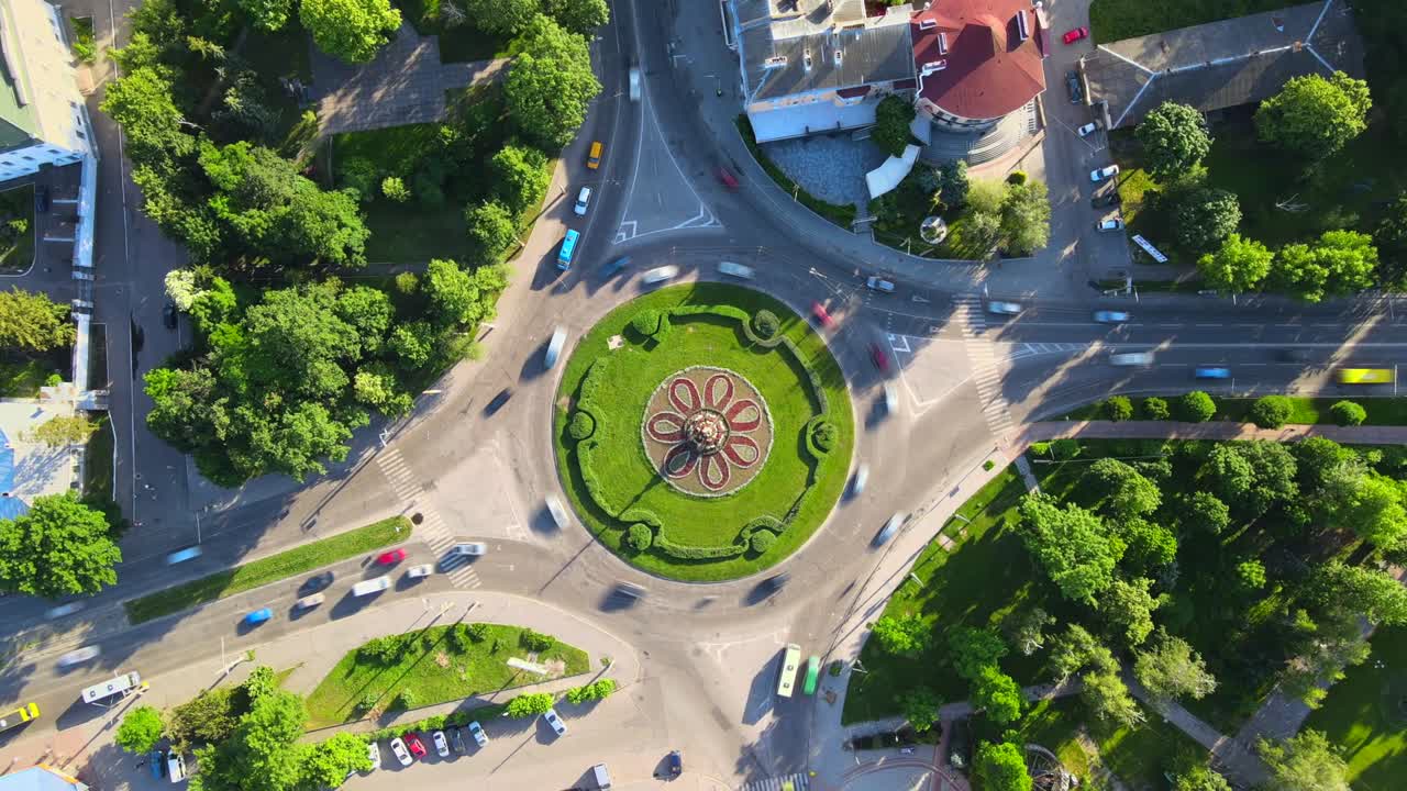 4k aerial view timelapse of roundabout road with circular cars in small european city at sunny day