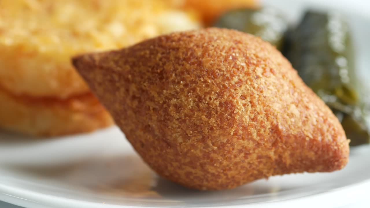 Kibbeh with pickles on a plate