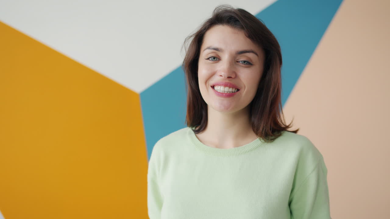 Woman Smiling and Giving a Thumbs Up