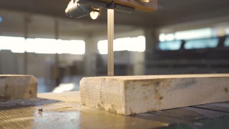 carpenter is cutting wood on a band saw.