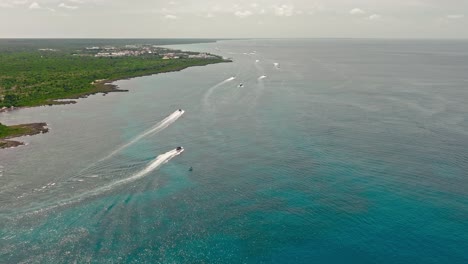 many speedboats cruising along bayahibe lush coast, la romana in dominican republic