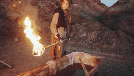 woman with torch standing by bathtub in dystopian world